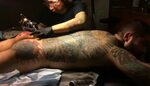 Alex Minsky shows how his butt gets a new tattoo. blockquote